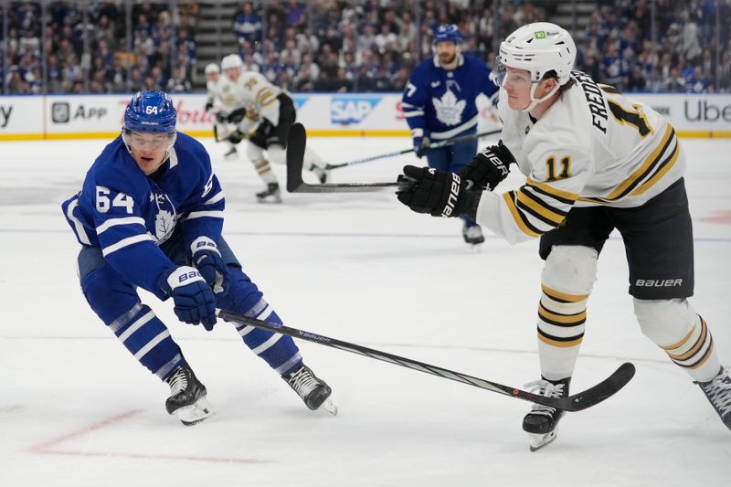 Apr 24, 2024; Toronto, Ontario, CAN; Boston Bruins forward Trent Frederic (11) scores on his shot as Toronto Maple Leafs forward David Kampf (64) looks on during the second period of game three of the first round of the 2024 Stanley Cup Playoffs at Scotiabank Arena. Mandatory Credit: John E. Sokolowski-USA TODAY Sports