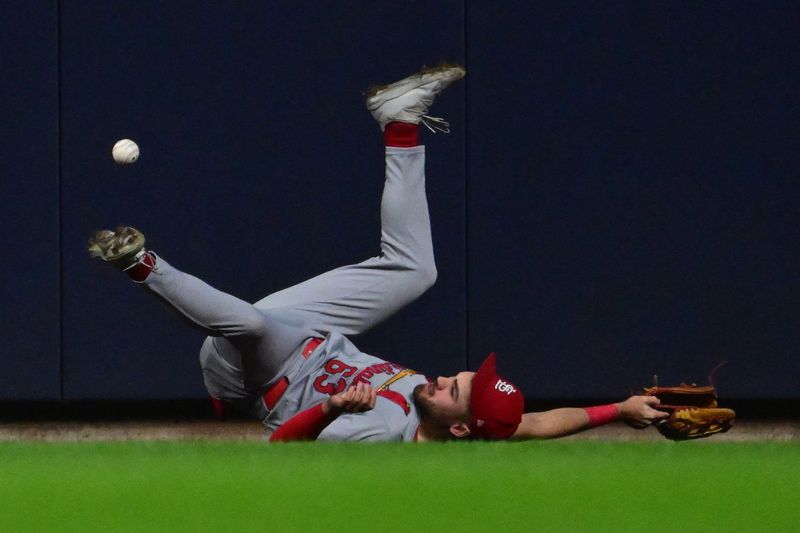 May 11, 2024; Milwaukee, Wisconsin, USA; St. Louis Cardinals center fielder Mike Siani (63) falls while trying to catch a ball hit by Milwaukee Brewers first baseman Rhys Hoskins (not pictured) for a three-run home run in the seventh inning at American Family Field. Mandatory Credit: Benny Sieu-USA TODAY Sports