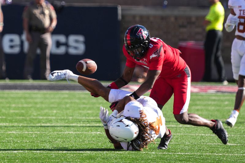 Sep 24, 2022; Lubbock, Texas, USA; Texas Longhorns wide receiver Jordan Whittington (4) drops a pass after being hit by Texas Tech Red Raiders defensive back Rayshad Williams (0) during a game at Jones AT&T Stadium. Mandatory Credit: Aaron E. Martinez/Austin American-Statesman via USA TODAY NETWORK