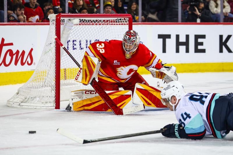 Jan 5, 2026; Calgary, Alberta, CAN; Calgary Flames goaltender Dustin Wolf (32) guards his net against the Seattle Kraken during the third period at Scotiabank Saddledome. Mandatory Credit: Sergei Belski-Imagn Images