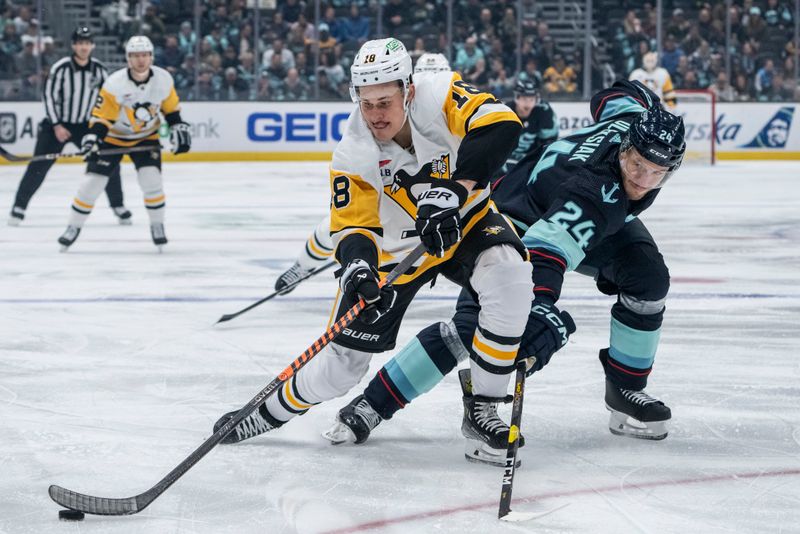 Feb 29, 2024; Seattle, Washington, USA; Pittsburgh Penguins forward Jesse Puljujarvi (18) and Seattle Kraken defenseman Jamie Oleksiak (24) battle for the puck during the first period at Climate Pledge Arena. Mandatory Credit: Stephen Brashear-USA TODAY Sports