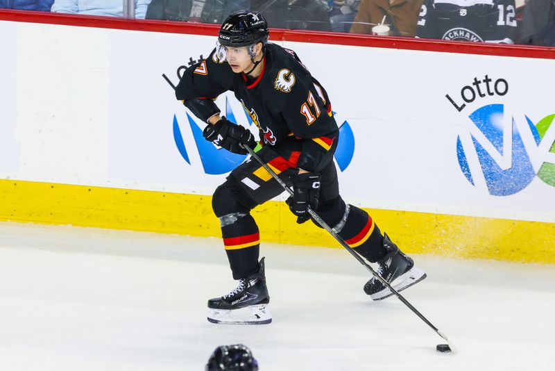 Jan 27, 2024; Calgary, Alberta, CAN; Calgary Flames center Yegor Sharangovich (17) controls the puck against the Chicago Blackhawks during the first period at Scotiabank Saddledome. Mandatory Credit: Sergei Belski-USA TODAY Sports