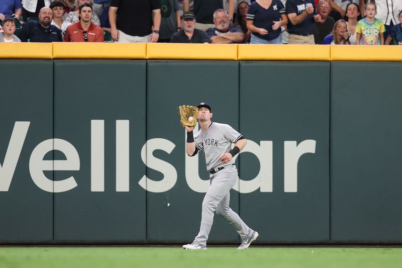 Aug 16, 2023; Atlanta, Georgia, USA; New York Yankees left fielder Billy McKinney (57) makes a catch against the Atlanta Braves in the seventh inning at Truist Park. Mandatory Credit: Brett Davis-USA TODAY Sports