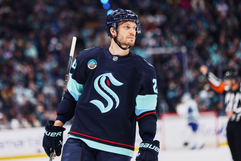 Feb 28, 2026; Seattle, Washington, USA;  Seattle Kraken defenseman Jamie Oleksiak (24) looks on during the first period against the Vancouver Canucks at Climate Pledge Arena. Mandatory Credit: Blake Dahlin-Imagn Images