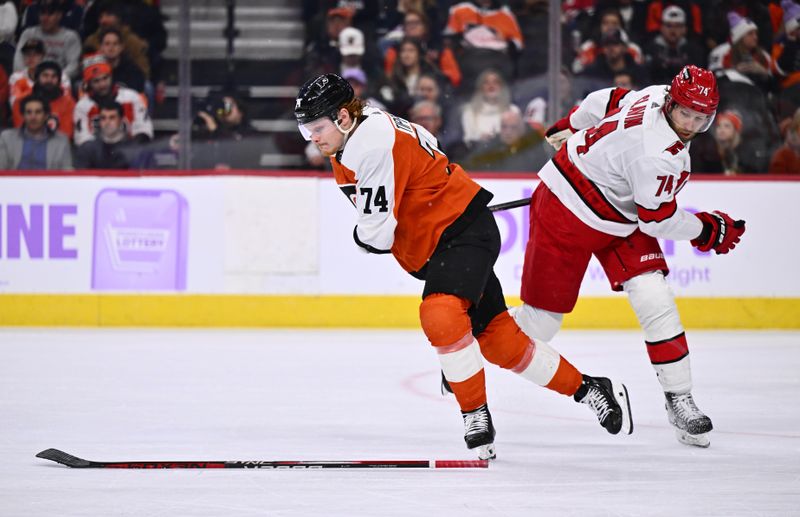 Nov 28, 2023; Philadelphia, Pennsylvania, USA; Philadelphia Flyers right wing Owen Tippett (74) collides with Carolina Hurricanes defenseman Jaccob Slavin (74) in the second period at Wells Fargo Center. Mandatory Credit: Kyle Ross-USA TODAY Sports