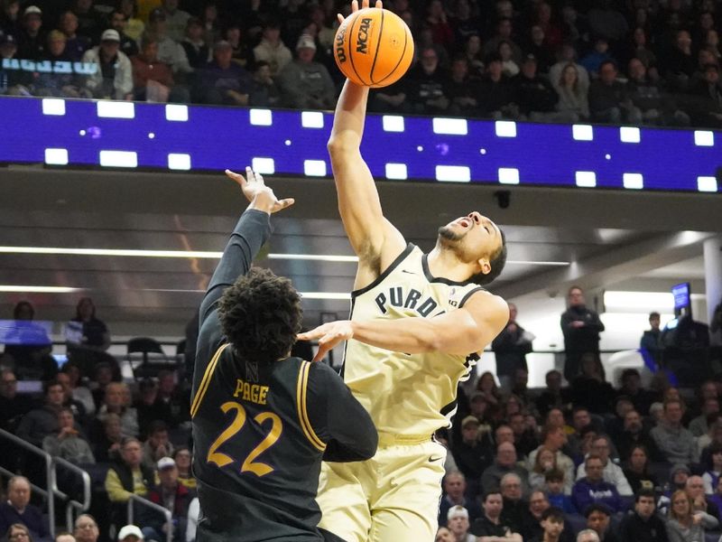 Mar 4, 2026; Evanston, Illinois, USA; Northwestern Wildcats forward Arrinten Page (22) defends Purdue Boilermakers forward Trey Kaufman-Renn (4) during the first half at Welsh-Ryan Arena. Mandatory Credit: David Banks-Imagn Images