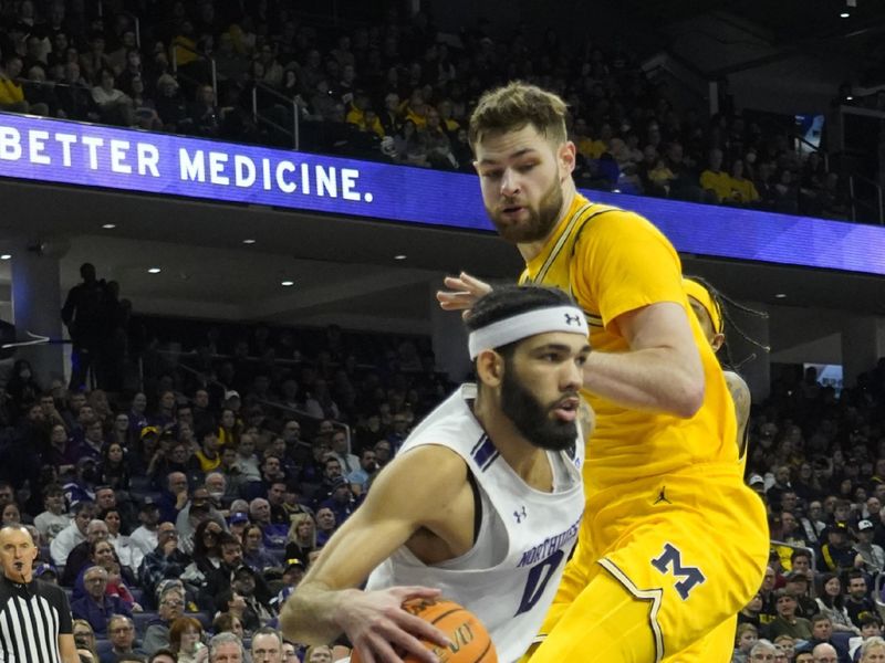 Feb 2, 2023; Evanston, Illinois, USA; Michigan Wolverines center Hunter Dickinson (1) defends Northwestern Wildcats guard Boo Buie (0) during the second half at Welsh-Ryan Arena. Mandatory Credit: David Banks-USA TODAY Sports