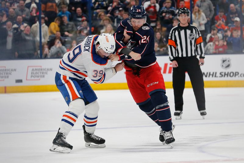 Mar 7, 2024; Columbus, Ohio, USA; Columbus Blue Jackets right wing Mathieu Olivier (24) and Edmonton Oilers center Sam Carrick (39) fight during the first period at Nationwide Arena. Mandatory Credit: Russell LaBounty-USA TODAY Sports