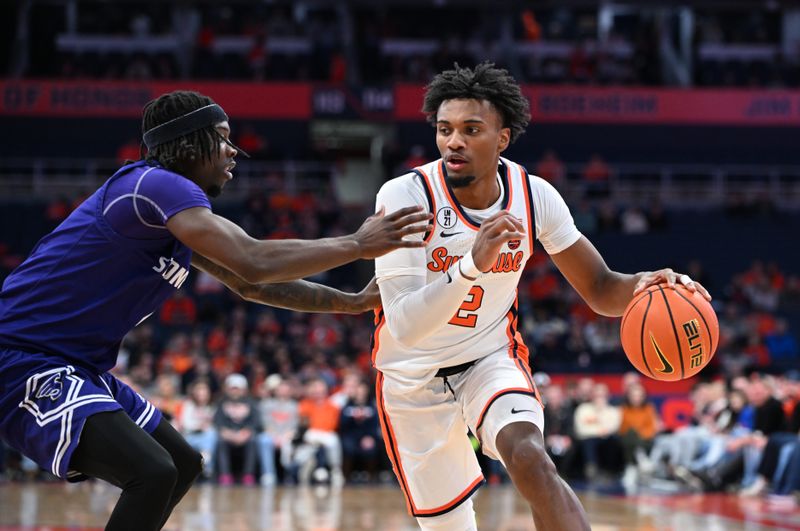 Dec 22, 2025; Syracuse, New York, USA; Syracuse Orange guard J.J. Starling (2) tries to get the ball past Stonehill Skyhawks guard Davante Hackett (4) in the second half at the JMA Wireless Dome. Mandatory Credit: Mark Konezny-Imagn Images