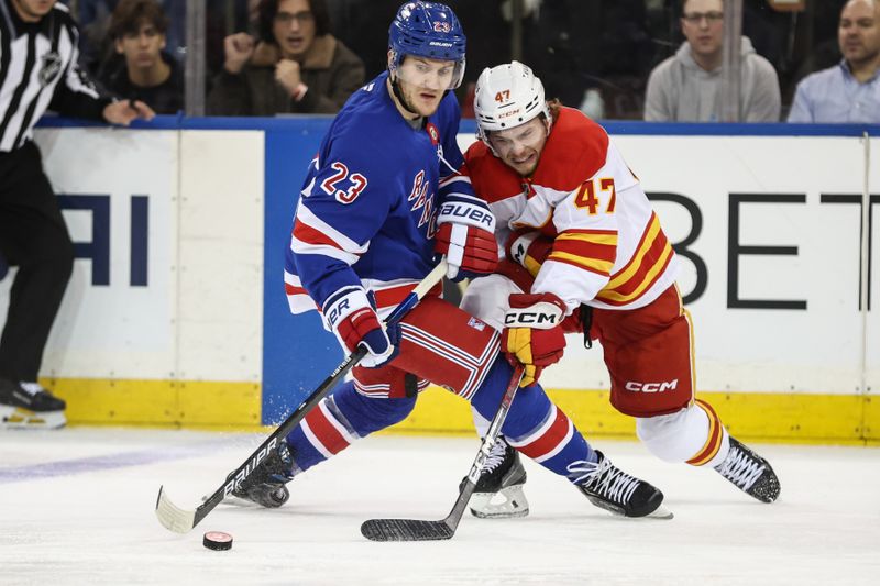 Mar 18, 2025; New York, New York, USA;  New York Rangers defenseman Adam Fox (23) and Calgary Flames center Connor Zary (47) battle for control of the puck in the third period at Madison Square Garden. Mandatory Credit: Wendell Cruz-Imagn Images