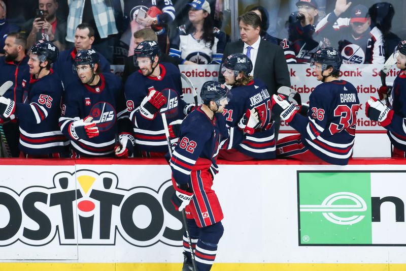 Dec 22, 2023; Winnipeg, Manitoba, CAN;  Winnipeg Jets forward Nino Niederreiter (62) is congratulated by his team mates on his goal against the Boston Bruins during the third period at Canada Life Centre. Mandatory Credit: Terrence Lee-USA TODAY Sports