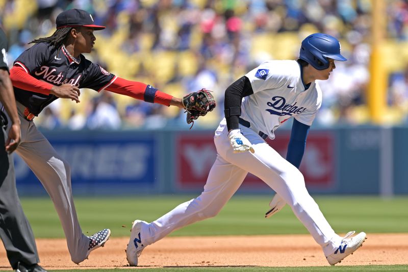 Apr 17, 2024; Los Angeles, California, USA; Los Angeles Dodgers designated hitter player Shohei Ohtani (17) is tagged out by Washington Nationals shortstop CJ Abrams (5) in a run down play in the sixth inning at Dodger Stadium. Mandatory Credit: Jayne Kamin-Oncea-USA TODAY Sports