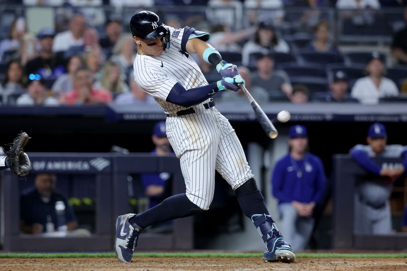 Jun 9, 2024; Bronx, New York, USA; New York Yankees right fielder Aaron Judge (99) hits a solo home run against the Los Angeles Dodgers during the eighth inning at Yankee Stadium. Mandatory Credit: Brad Penner-USA TODAY Sports