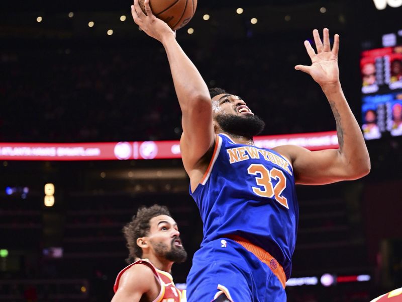 ATLANTA, GA - November 6:  Karl-Anthony Towns #32 of the New York Knicks shoots the ball during the game against the Atlanta Hawks on November 6, 2024 at State Farm Arena in Atlanta, Georgia.  NOTE TO USER: User expressly acknowledges and agrees that, by downloading and/or using this Photograph, user is consenting to the terms and conditions of the Getty Images License Agreement. Mandatory Copyright Notice: Copyright 2024 NBAE (Photo by Adam Hagy/NBAE via Getty Images)