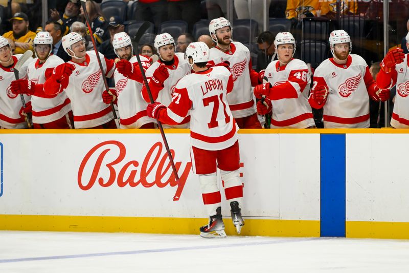 Oct 19, 2024; Nashville, Tennessee, USA; Detroit Red Wings center Dylan Larkin (71) celebrates his goal with his teammates  against the Nashville Predators during the second period at Bridgestone Arena. Mandatory Credit: Steve Roberts-Imagn Images