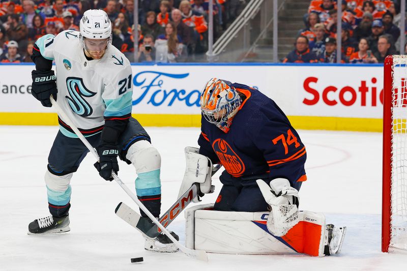 Jan 18, 2024; Edmonton, Alberta, CAN; Seattle Kraken forward Alex Weinberg (21) tries to get to a loose puck in front of Edmonton Oilers goaltender Stuart Skinner (74) during the second period at Rogers Place. Mandatory Credit: Perry Nelson-USA TODAY Sports