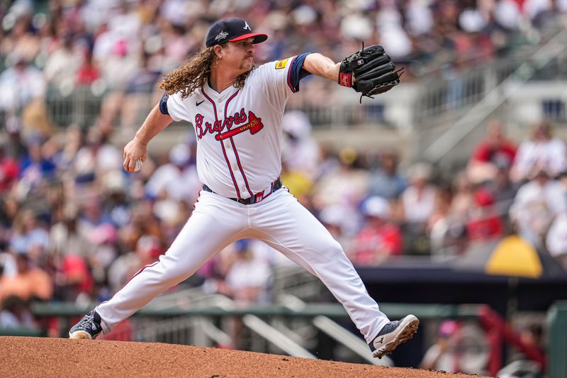 Apr 20, 2025; Cumberland, Georgia, USA; Atlanta Braves starting pitcher Grant Holmes (66) pitches against the Minnesota Twins during the second inning at Truist Park. Mandatory Credit: Dale Zanine-Imagn Images