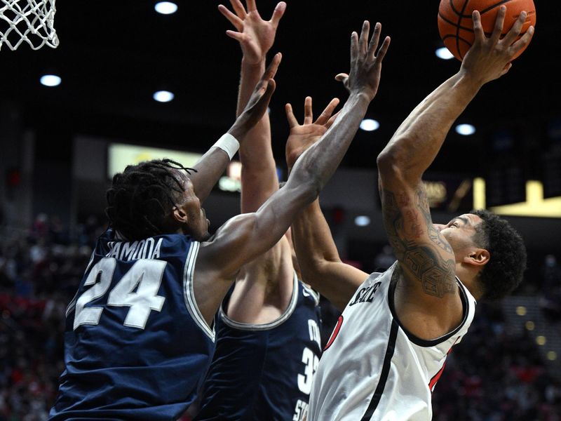 Jan 25, 2023; San Diego, California, USA; San Diego State Aztecs guard Matt Bradley (20) shoots the ball over Utah State Aggies forward Zee Hamoda (24) during the first half at Viejas Arena. Mandatory Credit: Orlando Ramirez-USA TODAY Sports