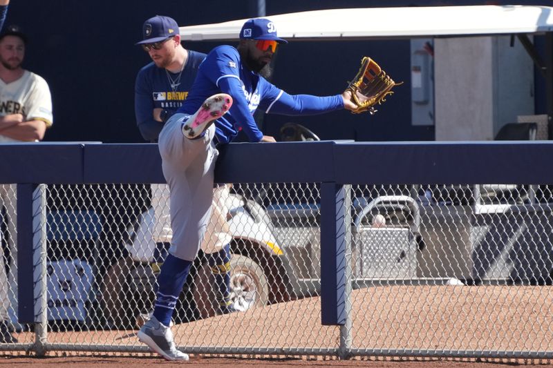 Feb 26, 2025; Phoenix, Arizona, USA; Los Angeles Dodgers outfielder Teoscar Hernández (37) tries to catch foul ball against the Milwaukee Brewers during the third inning at American Family Fields of Phoenix. Mandatory Credit: Rick Scuteri-Imagn Images