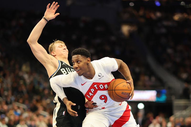 MILWAUKEE, WISCONSIN - NOVEMBER 12: RJ Barrett #9 of the Toronto Raptors drives to the basket against AJ Green #20 of the Milwaukee Bucks during the first half of a game in the NBA Emirates Cup at Fiserv Forum on November 12, 2024 in Milwaukee, Wisconsin. NOTE TO USER: User expressly acknowledges and agrees that, by downloading and or using this photograph, User is consenting to the terms and conditions of the Getty Images License Agreement. (Photo by Stacy Revere/Getty Images)