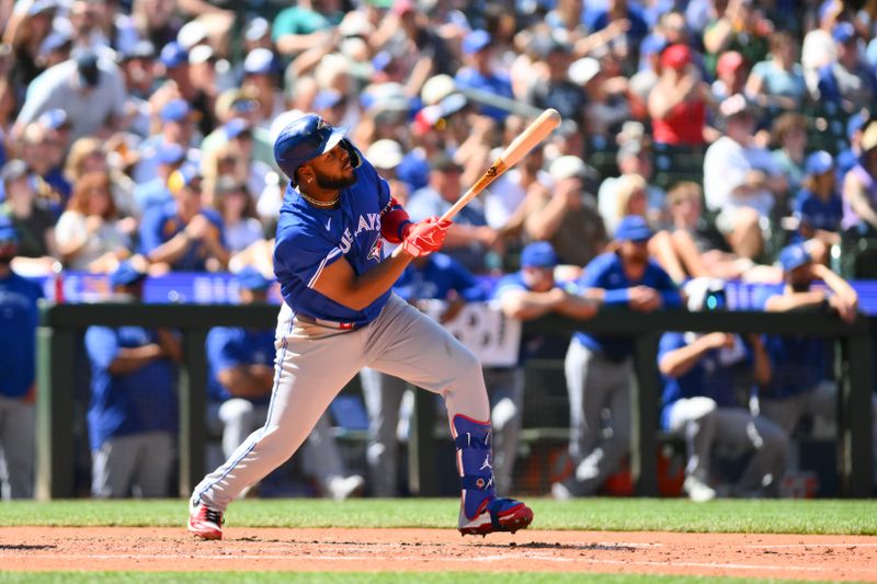 Jul 6, 2024; Seattle, Washington, USA; Toronto Blue Jays first baseman Vladimir Guerrero Jr. (27) hits an RBI sacrifice fly against the Seattle Mariners during the eighth inning at T-Mobile Park. Mandatory Credit: Steven Bisig-USA TODAY Sports