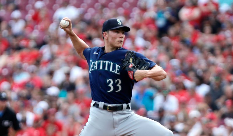 Sep 4, 2023; Cincinnati, Ohio, USA; Seattle Mariners starting pitcher Bryan Woo (33) throws against the Cincinnati Reds during the first inning at Great American Ball Park. Mandatory Credit: David Kohl-USA TODAY Sports