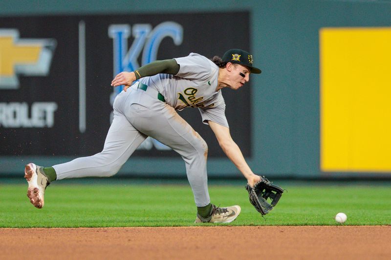 May 18, 2024; Kansas City, Missouri, USA; Oakland Athletics second base Zack Gelof (20) reaches for a ground ball during the eighth inning against the Kansas City Royals at Kauffman Stadium. Mandatory Credit: William Purnell-USA TODAY Sports