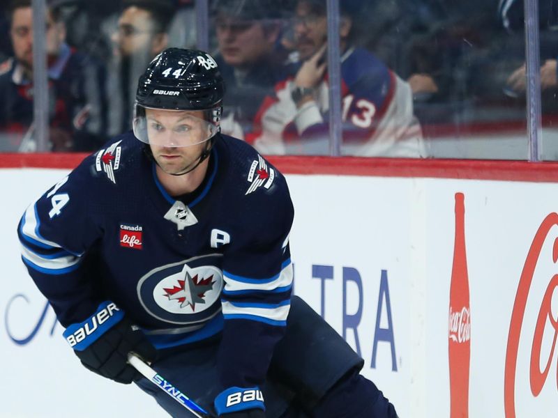 Nov 30, 2023; Winnipeg, Manitoba, CAN; Winnipeg Jets defenseman Josh Morrissey (44) looks to make a pass against the Edmonton Oilers during the first period at Canada Life Centre. Mandatory Credit: Terrence Lee-USA TODAY Sports