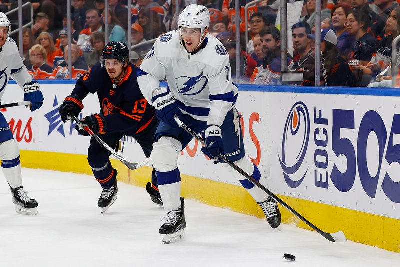 Dec 14, 2023; Edmonton, Alberta, CAN; Tampa Bay Lightning defensemen Hayden Fleury (7) makes a pass in front of Edmonton Oilers forward Mattias Janmark (13) during the first period at Rogers Place. Mandatory Credit: Perry Nelson-USA TODAY Sports