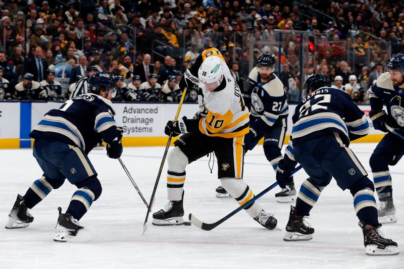 Nov 15, 2024; Columbus, Ohio, USA; Pittsburgh Penguins left wing Drew O'Connor (10) loses control of the puck as Columbus Blue Jackets defenseman Jake Christiansen (2) and defenseman Jordan Harris (22) defend during the third period at Nationwide Arena. Mandatory Credit: Russell LaBounty-Imagn Images