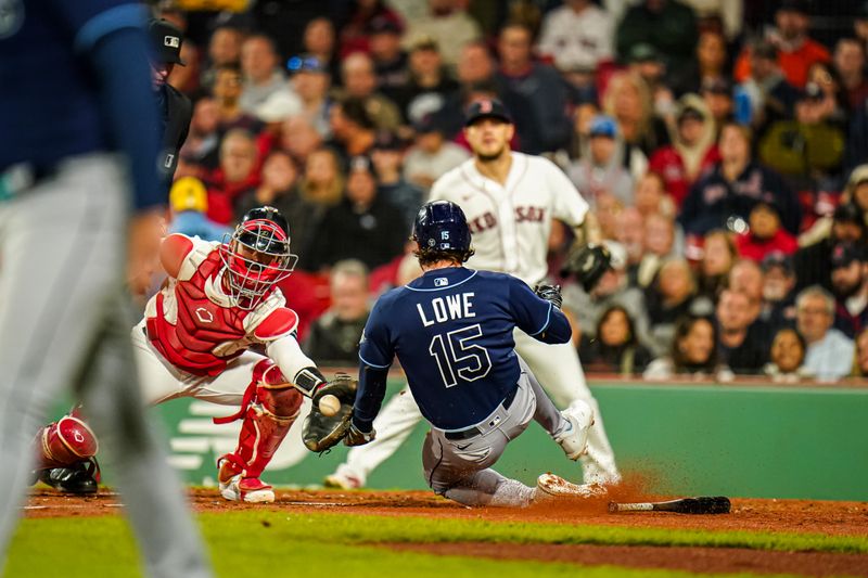 Sep 26, 2023; Boston, Massachusetts, USA; Tampa Bay Rays right fielder Josh Lowe (15) safe at home plat against Boston Red Sox catcher Reese McGuire (3) in the third inning at Fenway Park. Mandatory Credit: David Butler II-USA TODAY Sports