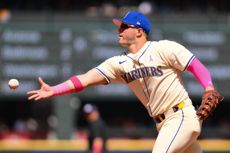 May 12, 2024; Seattle, Washington, USA; Seattle Mariners first baseman Ty France (23) throws the ball to first base for a force out on the Oakland Athletics during the first inning at T-Mobile Park. Mandatory Credit: Steven Bisig-USA TODAY Sports