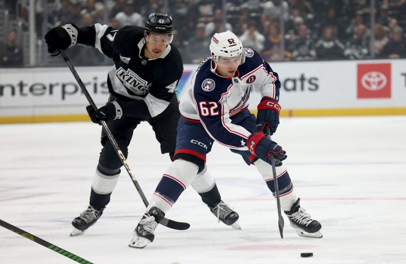 Nov 9, 2024; Los Angeles, California, USA; Columbus Blue Jackets right wing Kevin Labanc (62) controls the puck against Los Angeles Kings left wing Andre Lee (47) during the first period at Crypto.com Arena. Mandatory Credit: Jason Parkhurst-Imagn Images