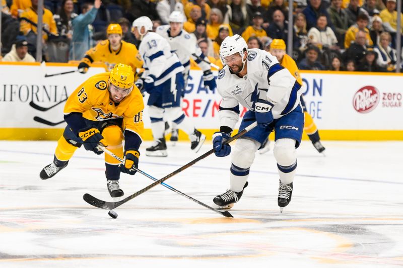 Nov 29, 2024; Nashville, Tennessee, USA;  Nashville Predators defenseman Adam Wilsby (83) and Tampa Bay Lightning center Luke Glendening (11) battle for the puck during the third period at Bridgestone Arena. Mandatory Credit: Steve Roberts-Imagn Images
