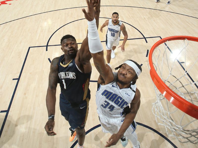 NEW ORLEANS, LA - MARCH 13:  Wendell Carter Jr. #34 of the Orlando Magic and Zion Williamson #1 of the New Orleans Pelicans go up for the rebound during the game on March 13, 2025 at the Smoothie King Center in New Orleans, Louisiana. NOTE TO USER: User expressly acknowledges and agrees that, by downloading and or using this Photograph, user is consenting to the terms and conditions of the Getty Images License Agreement. Mandatory Copyright Notice: Copyright 2025 NBAE (Photo by Layne Murdoch Jr./NBAE via Getty Images)