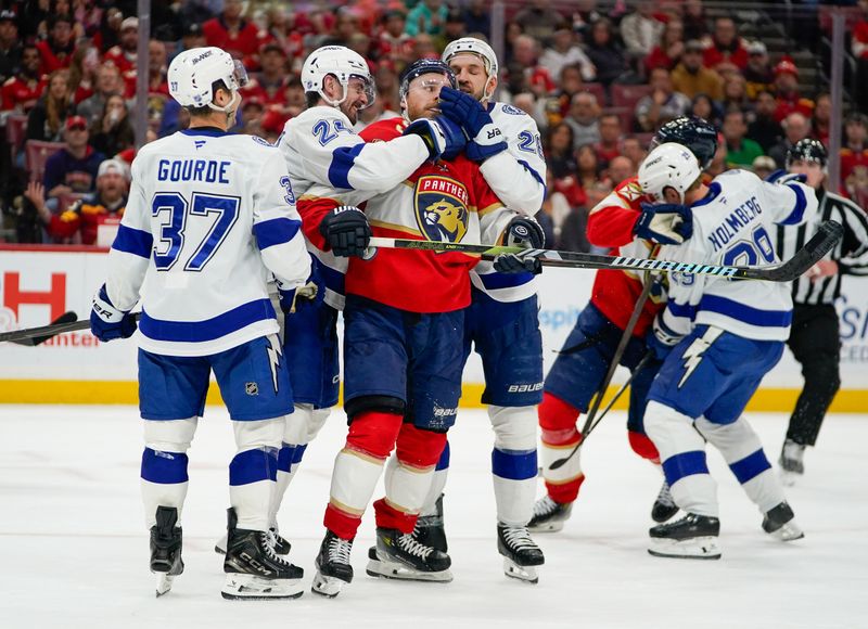Dec 27, 2025; Sunrise, Florida, USA; Florida Panthers center Sam Bennett (9) fights with Tampa Bay Lightning defenseman Max Crozier (24) and right wing Pontus Holmberg (29) at Amerant Bank Arena. Mandatory Credit: Jeff Romance-Imagn Images