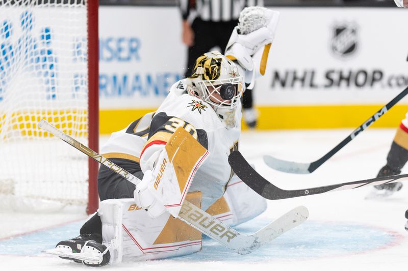 Sep 24, 2023; San Jose, California, USA;  Vegas Golden Knights goalie Jiri Patera (30) blocks the puck with his mask during the second period against the San Jose Sharks at SAP Center at San Jose. Mandatory Credit: Stan Szeto-USA TODAY Sports