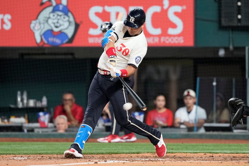 Jun 21, 2024; Arlington, Texas, USA; Texas Rangers first baseman Nathaniel Lowe (30) connects for a single against the Kansas City Royals during the fourth inning at Globe Life Field. Mandatory Credit: Jim Cowsert-USA TODAY Sports