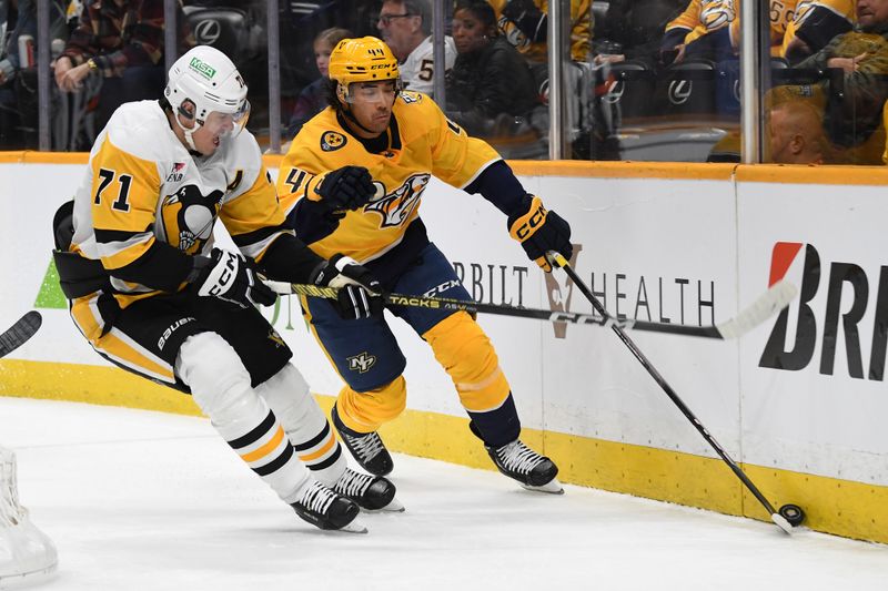 Nov 28, 2023; Nashville, Tennessee, USA; Nashville Predators left wing Kiefer Sherwood (44) skates with the puck against Pittsburgh Penguins center Evgeni Malkin (71) during the first period at Bridgestone Arena. Mandatory Credit: Christopher Hanewinckel-USA TODAY Sports