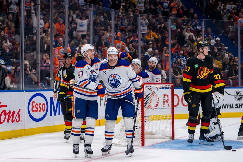 Nov 9, 2024; Vancouver, British Columbia, CAN; Edmonton Oilers forward Connor McDavid (97) celebrates with forward Zach Hyman (18) after scoring a goal against the Vancouver Canucks during the third period at Rogers Arena. Mandatory Credit: Bob Frid-Imagn Images