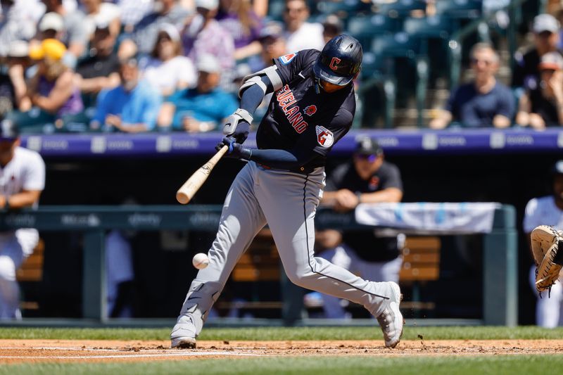 May 27, 2024; Denver, Colorado, USA; Cleveland Guardians first baseman Josh Naylor (22) hits a sacrifice RBI in the second inning against the Colorado Rockies at Coors Field. Mandatory Credit: Isaiah J. Downing-USA TODAY Sports