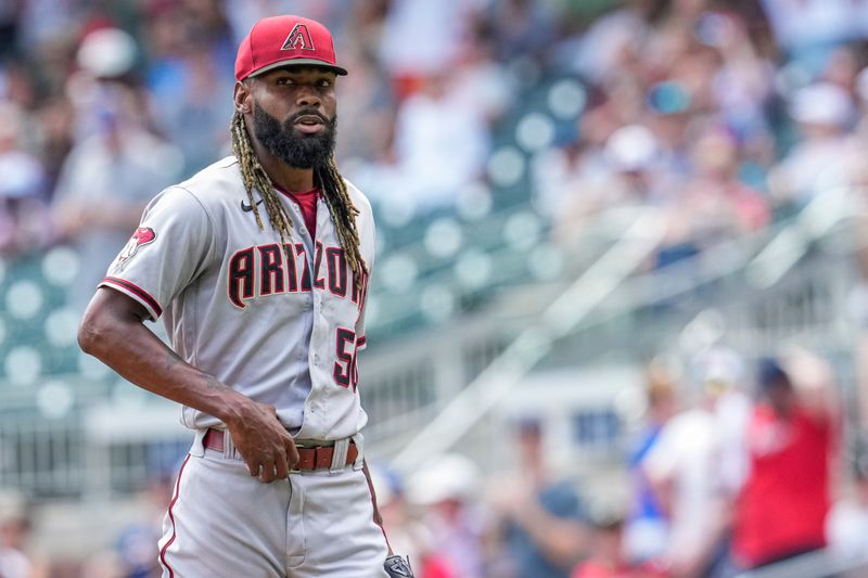 Jul 20, 2023; Cumberland, Georgia, USA; Arizona Diamondbacks relief pitcher Miguel Castro (50) leaves the field after surrendering a three run home run to Atlanta Braves third baseman Austin Riley (27) (not shown) during the eighth inning at Truist Park. Mandatory Credit: Dale Zanine-USA TODAY Sports