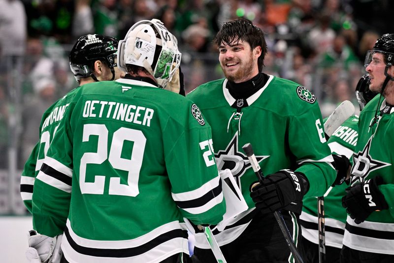 May 21, 2025; Dallas, Texas, USA; Dallas Stars goaltender Jake Oettinger (29) reacts with defenseman Lian Bichsel (6) after defeating the Edmonton Oilers in game one of the Western Conference Final of the 2025 Stanley Cup Playoffs at American Airlines Center. Mandatory Credit: Jerome Miron-Imagn Images