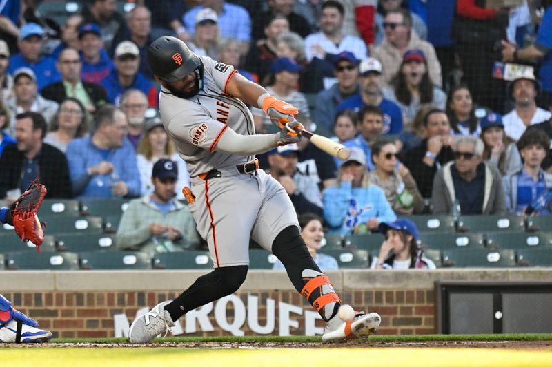 May 6, 2025; Chicago, Illinois, USA;  San Francisco Giants outfielder Heliot Ramos (17) hits an RBI single against the Chicago Cubs during the second inning at Wrigley Field. Mandatory Credit: Matt Marton-Imagn Images