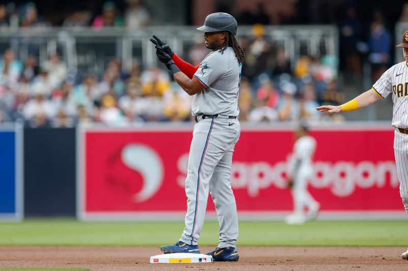 May 28, 2024; San Diego, California, USA; Miami Marlins first baseman Josh Bell (9) celebrates with the Marlins dugout after hitting a double in the first inning against the San Diego Padres at Petco Park. Mandatory Credit: David Frerker-USA TODAY Sports