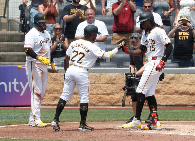 Jul 8, 2024; Pittsburgh, Pennsylvania, USA;  Pittsburgh Pirates first baseman Rowdy Tellez (left) and designated hitter Andrew McCutchen (22) greet shortstop Oneil Cruz (15) crossing home plate on a two run home run against the New York Mets during the fourth inning at PNC Park. Mandatory Credit: Charles LeClaire-USA TODAY Sports