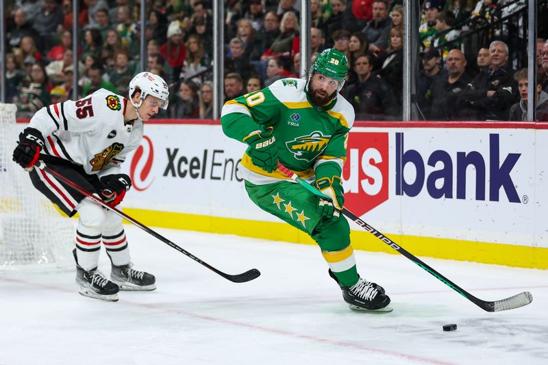 Dec 3, 2023; Saint Paul, Minnesota, USA; Minnesota Wild left wing Pat Maroon (20) skates with the puck as Chicago Blackhawks defenseman Kevin Korchinski (55) defends during the second period at Xcel Energy Center. Mandatory Credit: Matt Krohn-USA TODAY Sports