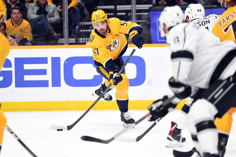 Jan 21, 2023; Nashville, Tennessee, USA; Nashville Predators defenseman Dante Fabbro (57) passes the puck in the final minute of the first period against the Los Angeles Kings at Bridgestone Arena. Mandatory Credit: Christopher Hanewinckel-USA TODAY Sports