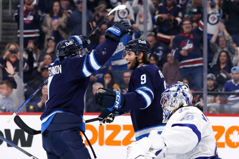 Jan 2, 2024; Winnipeg, Manitoba, CAN; Winnipeg Jets left wing Alex Iafallo (9) celebrates his second period goal against the Tampa Bay Lightning at Canada Life Centre. Mandatory Credit: James Carey Lauder-USA TODAY Sports