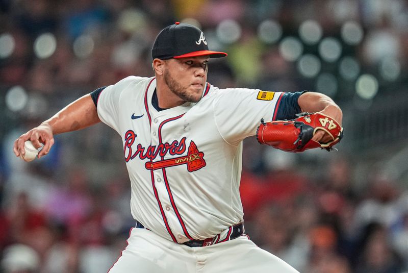 Jun 17, 2024; Cumberland, Georgia, USA; Atlanta Braves relief pitcher Joe Jimenez (77) pitches against the Detroit Tigers during the ninth inning at Truist Park. Mandatory Credit: Dale Zanine-USA TODAY Sports